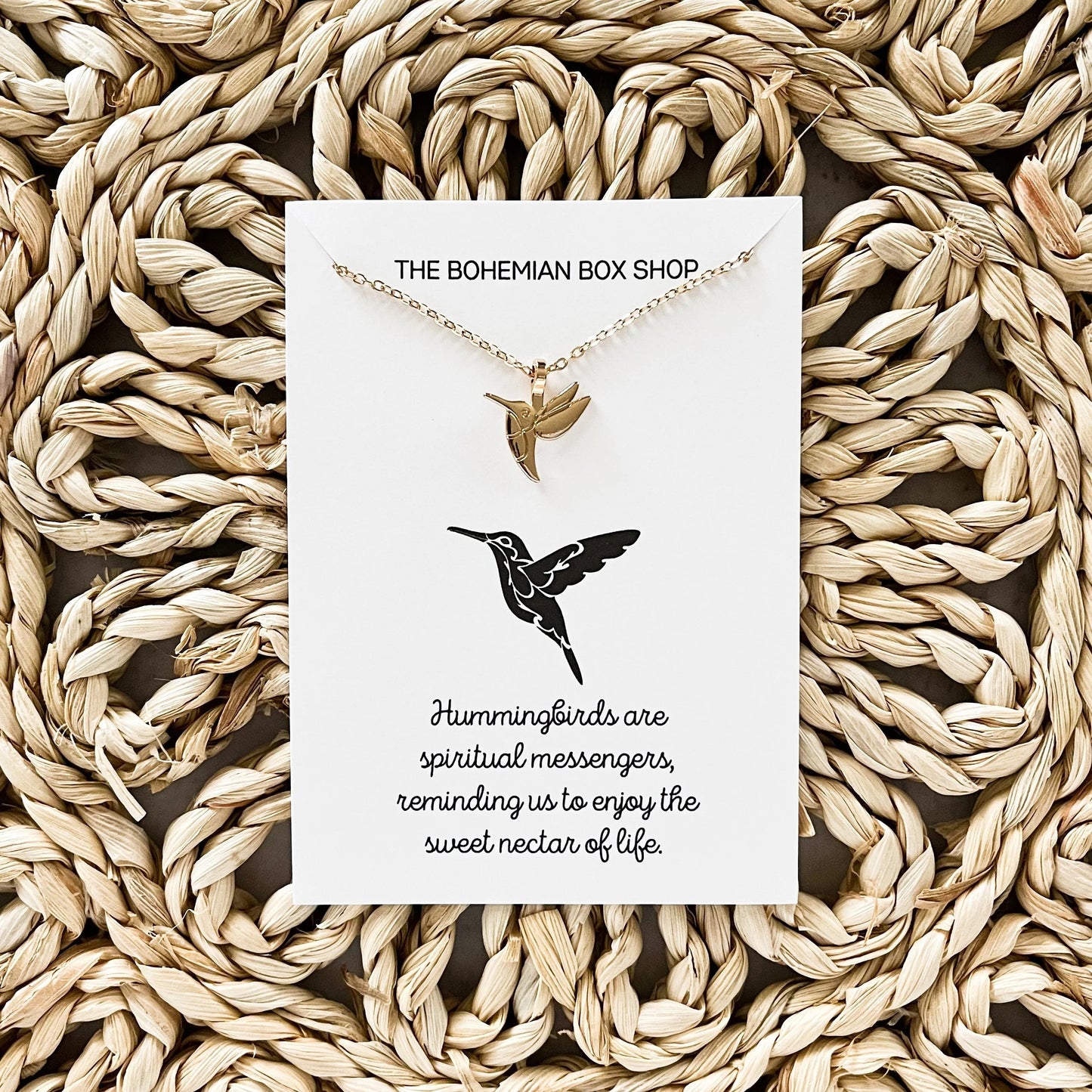 Hummingbird Charm Necklace with a card that reads “Hummingbirds are spiritual messengers, reminding us to enjoy the sweet nectar of life.”