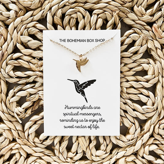 Hummingbird Charm Necklace with a card that reads “Hummingbirds are spiritual messengers, reminding us to enjoy the sweet nectar of life.”